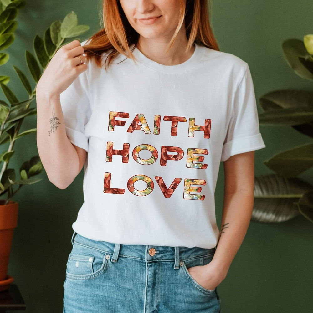 Positive Christian faith based gift idea shirt for religious friend or loved one. Bible verse and 1st Corinthians 13 quote - Faith, Hope and Love saying. Great matching floral casual graphic tee for a church convention, Sunday school or weekend service. Grab this for a birthday t-shirt outfit for a youth pastor or leader, minister or any other Christian family.