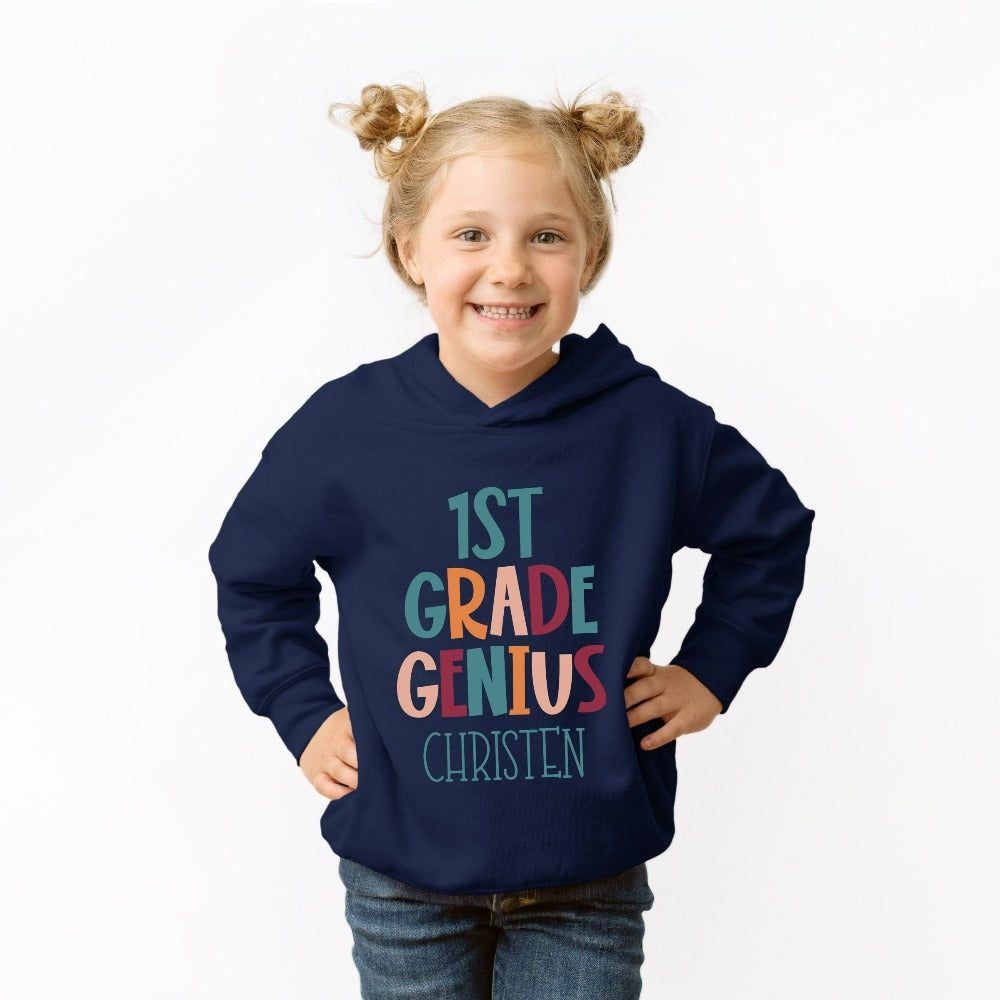 Customize this first grade, back to school sweatshirt gift idea for your genius. For first day of school, school field trips, 100 days of school, graduation or a new grade. Perfect name shirt outfit for everyday use in or out of classroom. 1st grade hoodie.