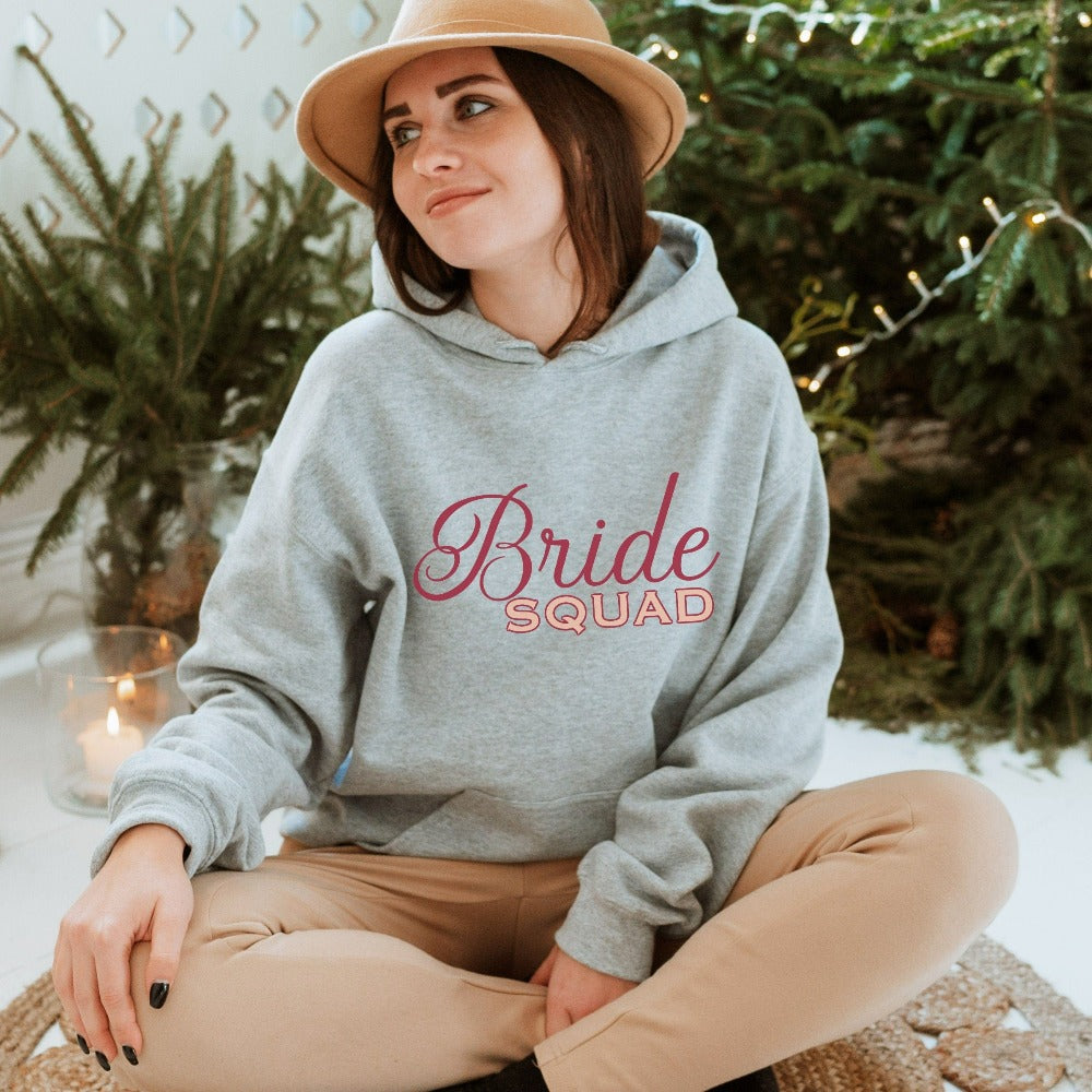 This matching bride squad sweatshirt is a perfect bridesmaid invitation or proposal box gift idea. Perfect as an engagement announcement surprise hoodie, bachelorette party outfit, gift for bridesmaid or maid of honor, rehearsal night dinner outfit for mother of the bride, mother of the groom and any other crew member involved in your wedding planning activities.