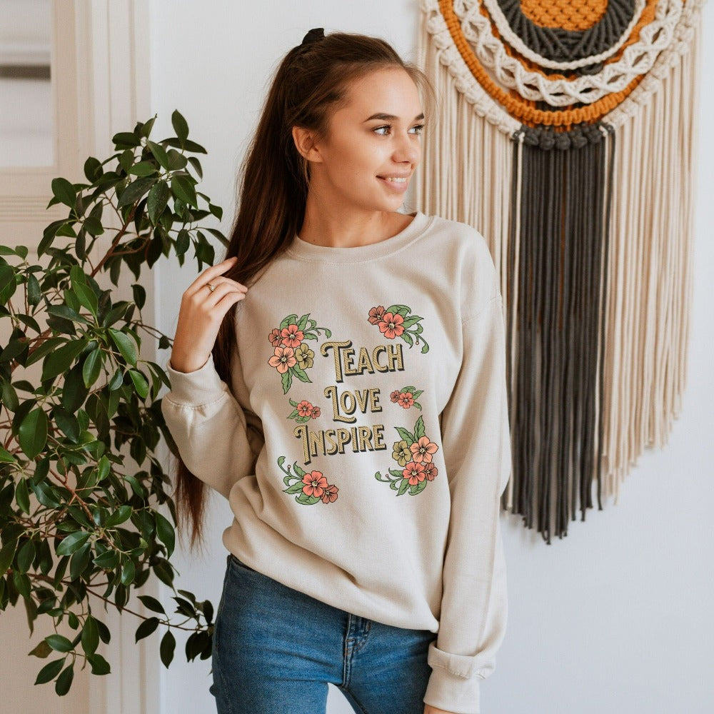 Floral botanical back to school teacher gift idea. This adorable graphic sweatshirt is for first day of school, last day, summer break or everyday appreciation present for your favorite kindergarten or grade teacher. Teach, Love, Inspire, Learn and Motivate in this positive outfit perfect for both classroom and field trip activities.
