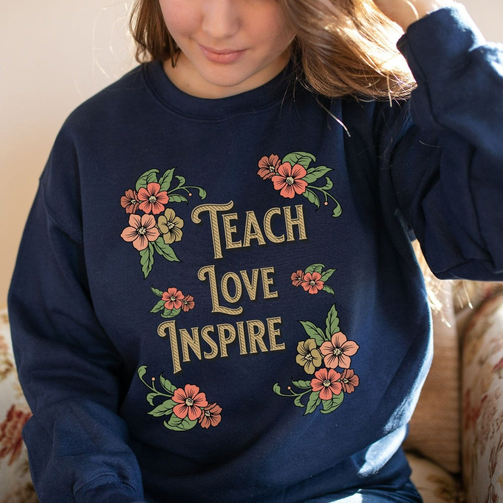 Floral botanical back to school teacher gift idea. This adorable graphic sweatshirt is for first day of school, last day, summer break or everyday appreciation present for your favorite kindergarten or grade teacher. Teach, Love, Inspire, Learn and Motivate in this positive outfit perfect for both classroom and field trip activities.