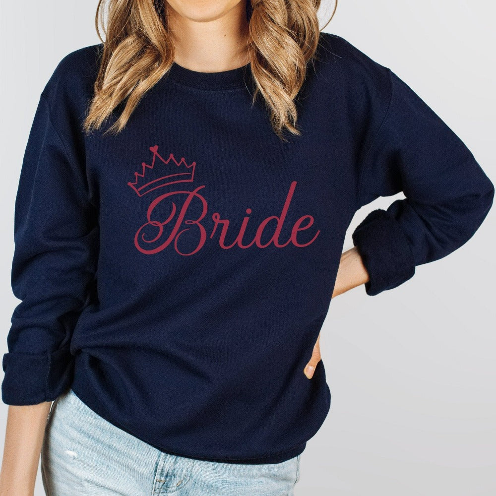This cute bride sweatshirt is a great addition to getting ready for your wedding day. Serves as an engagement announcement surprise shirt; bachelorette party outfit; gift from bridesmaid or maid of honor; rehearsal night dinner outfit; and errand top for your wedding planning activities. So, if you have a soon to be bride, future Mrs. friend, or future daughter-in-law, this top is a great gift idea for her.