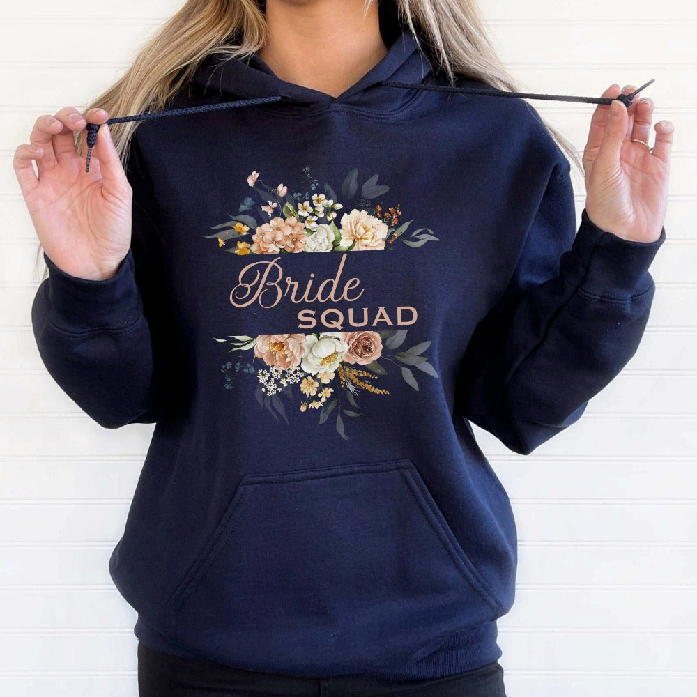 This matching floral bride squad sweatshirt is a perfect bridesmaid invitation gift idea for the proposal box. Serves as an engagement announcement surprise shirt, bachelorette party outfit, gift for bridesmaid or maid of honor, rehearsal night dinner outfit for mother of the bride or groom and any other crew member involved in your wedding planning activities. 