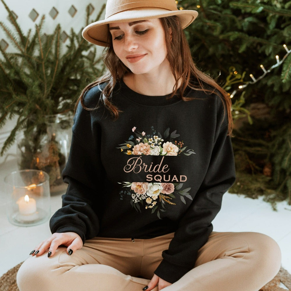 This matching floral bride squad sweatshirt is a perfect bridesmaid invitation gift idea for the proposal box. Serves as an engagement announcement surprise shirt, bachelorette party outfit, gift for bridesmaid or maid of honor, rehearsal night dinner outfit for mother of the bride or groom and any other crew member involved in your wedding planning activities.