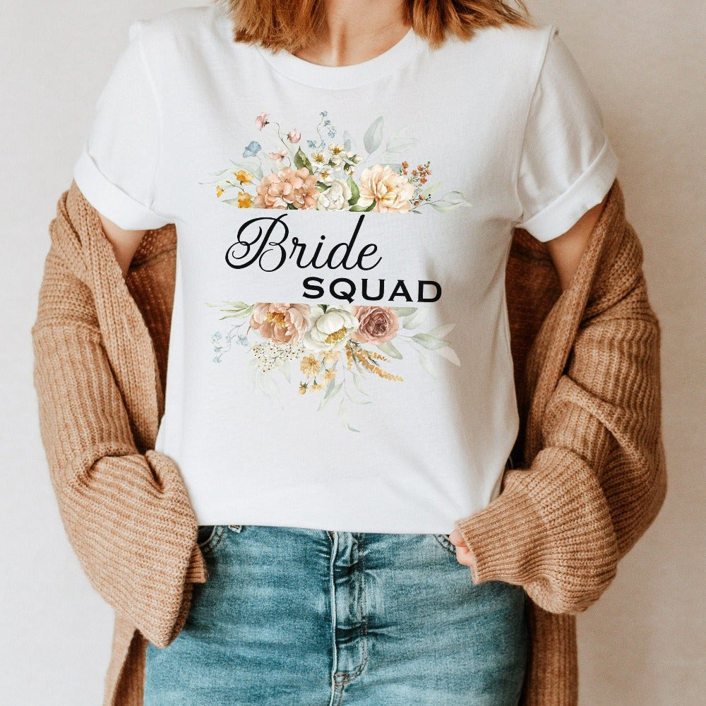 This matching floral bride squad shirt is a perfect bridesmaid invitation gift idea for the proposal box. Serves as an engagement announcement surprise shirt, bachelorette party outfit, gift for bridesmaid or maid of honor, rehearsal night dinner outfit for mother of the bride or groom and any other crew member involved in your wedding planning activities. 