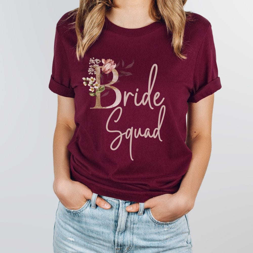 Floral bride squad shirt for maid of honor, bride team, bridesmaids, mother of the bride or groom and wedding party. Great idea for engagement announcement, bachelorette party, bridesmaid proposal box gift idea, rehearsal dinner, and after wedding parties. This cute getting ready casual tee is a perfect addition for the bride's crew, team or squad.