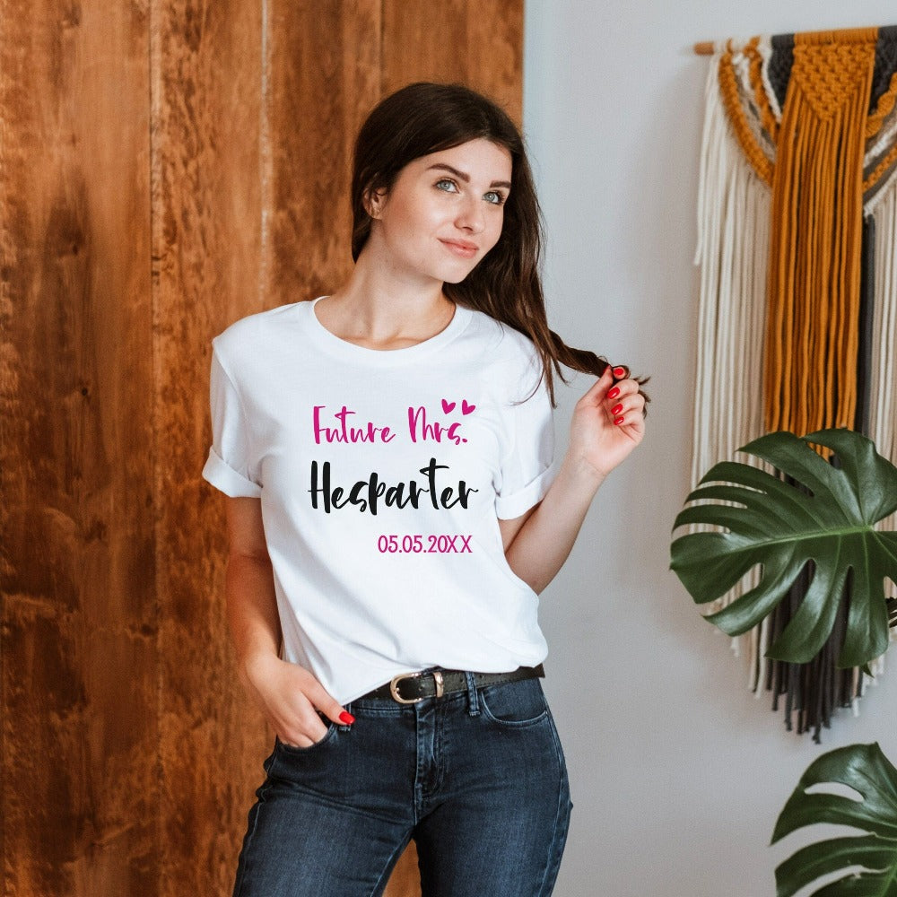 Grab this adorable wedding souvenir for the newest bride to be. Customized with name and date, this cute gift idea is perfect for a bridal shower present for the soon to be Mrs or engagement anniversary gift for wife/spouse. Custom personalized bachelorette shirt outfit.