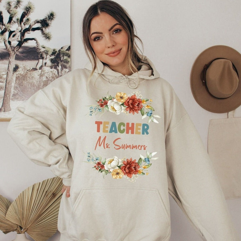 Customized floral botanical back to school teacher sweatshirt gift idea. This adorable shirt is for first day of school, last day, summer break or everyday appreciation present for your favorite kindergarten or grade teacher. Personalize with name with this positive outfit perfect for both classroom and field trip activities.