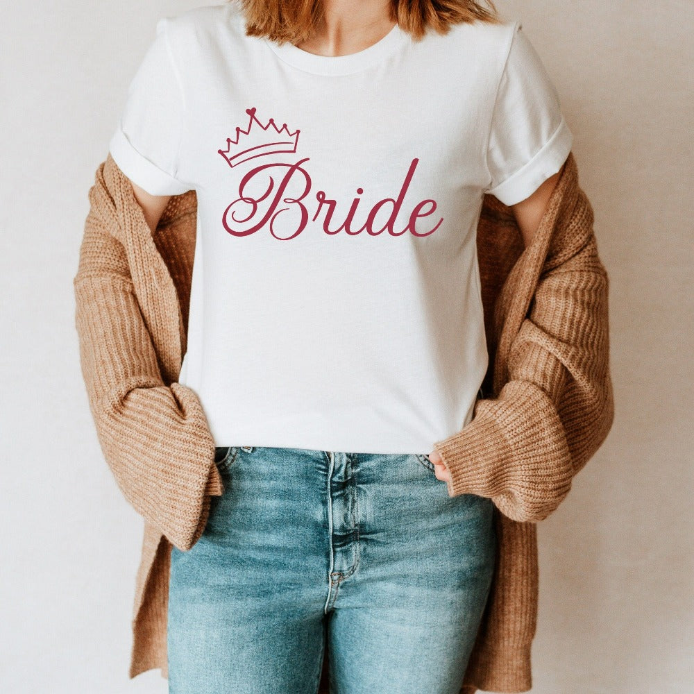 This cute bride shirt is a great addition to getting ready for your wedding day. Serves as an engagement announcement surprise shirt; bachelorette party outfit; gift from bridesmaid or maid of honor; rehearsal night dinner outfit; and errand top for your wedding planning activities. So, if you have a soon to be bride, future Mrs. friend, or future daughter-in-law, this casual tee is a great gift idea for her.