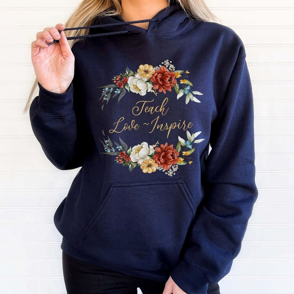 Floral botanical back to school teacher gift idea. This adorable sweatshirt is for first day of school, last day, summer break or everyday appreciation present for your favorite kindergarten or grade teacher. Teach, Love, Inspire, Learn and Motivate in this positive outfit perfect for both classroom and field trip activities.