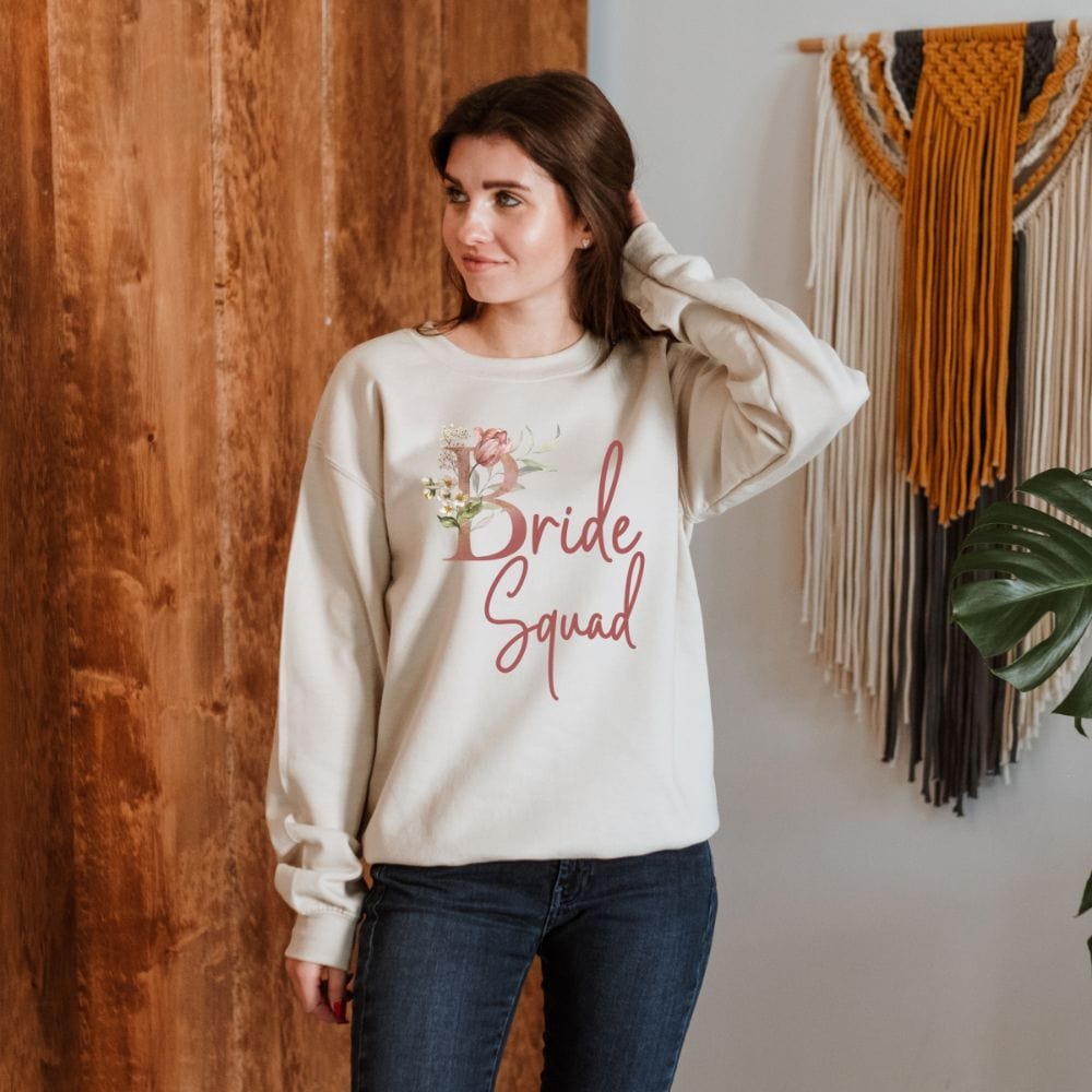 Floral bride squad sweatshirt for maid of honor, bride team, bridesmaids, mother of the bride or groom and wedding party. Great idea for engagement announcement, bachelorette party, bridesmaid proposal box gift idea, rehearsal dinner, and after wedding parties. This cute getting ready outfit is a perfect addition for the bride's crew, team or squad.