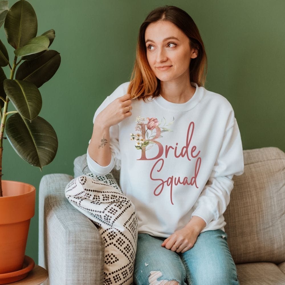 Floral bride squad sweatshirt for maid of honor, bride team, bridesmaids, mother of the bride or groom and wedding party. Great idea for engagement announcement, bachelorette party, bridesmaid proposal box gift idea, rehearsal dinner, and after wedding parties. This cute getting ready outfit is a perfect addition for the bride's crew, team or squad.
