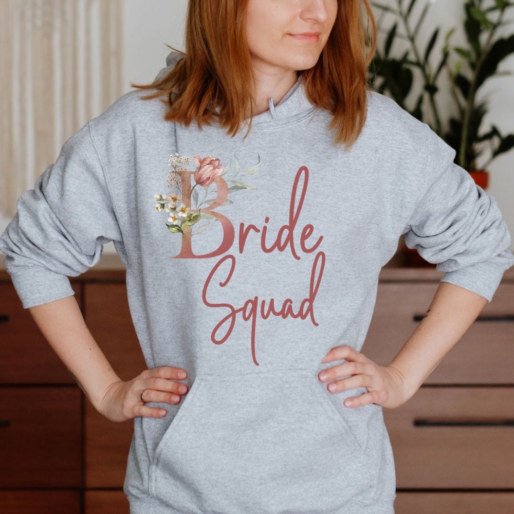 Floral bride squad hoodie for maid of honor, bride team, bridesmaids, mother of the bride or groom and wedding party. Great idea for engagement announcement, bachelorette party, bridesmaid proposal box gift idea, rehearsal dinner, and after wedding parties. This cute getting ready present is a perfect addition for the bride's crew, team or squad.