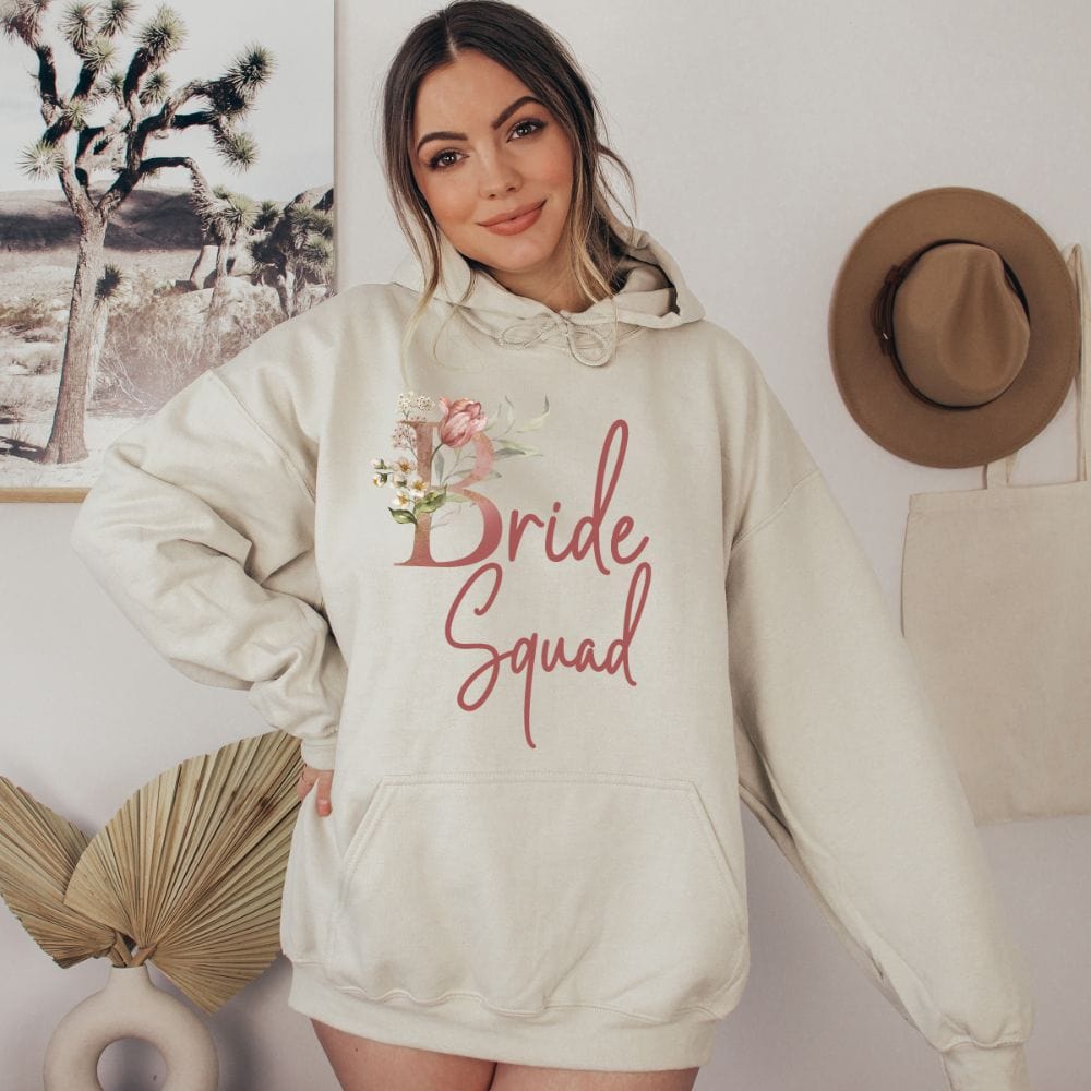 Floral bride squad hoodie for maid of honor, bride team, bridesmaids, mother of the bride or groom and wedding party. Great idea for engagement announcement, bachelorette party, bridesmaid proposal box gift idea, rehearsal dinner, and after wedding parties. This cute getting ready present is a perfect addition for the bride's crew, team or squad.