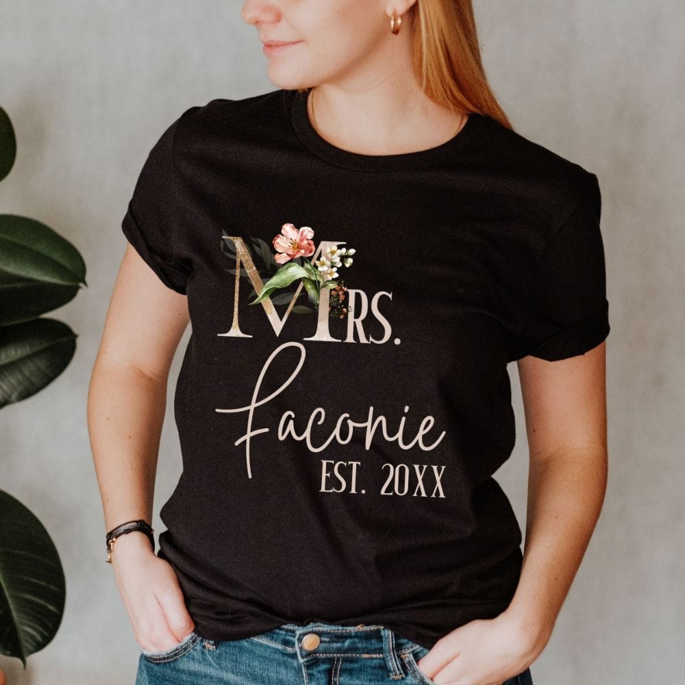 Customizable floral Mrs shirt for fiancée, wife, spouse, BFF or bestie on your wedding or anniversary. Great idea for engagement announcement, bachelorette party, bridesmaid gift idea, rehearsal dinner outfit, and after wedding party gift. This cute getting ready casual tee is a perfect idea for soon-to-be daughter-in-law, future Mrs. bride or as a honeymoon vacation souvenir. Personalize with name and date for a special touch.