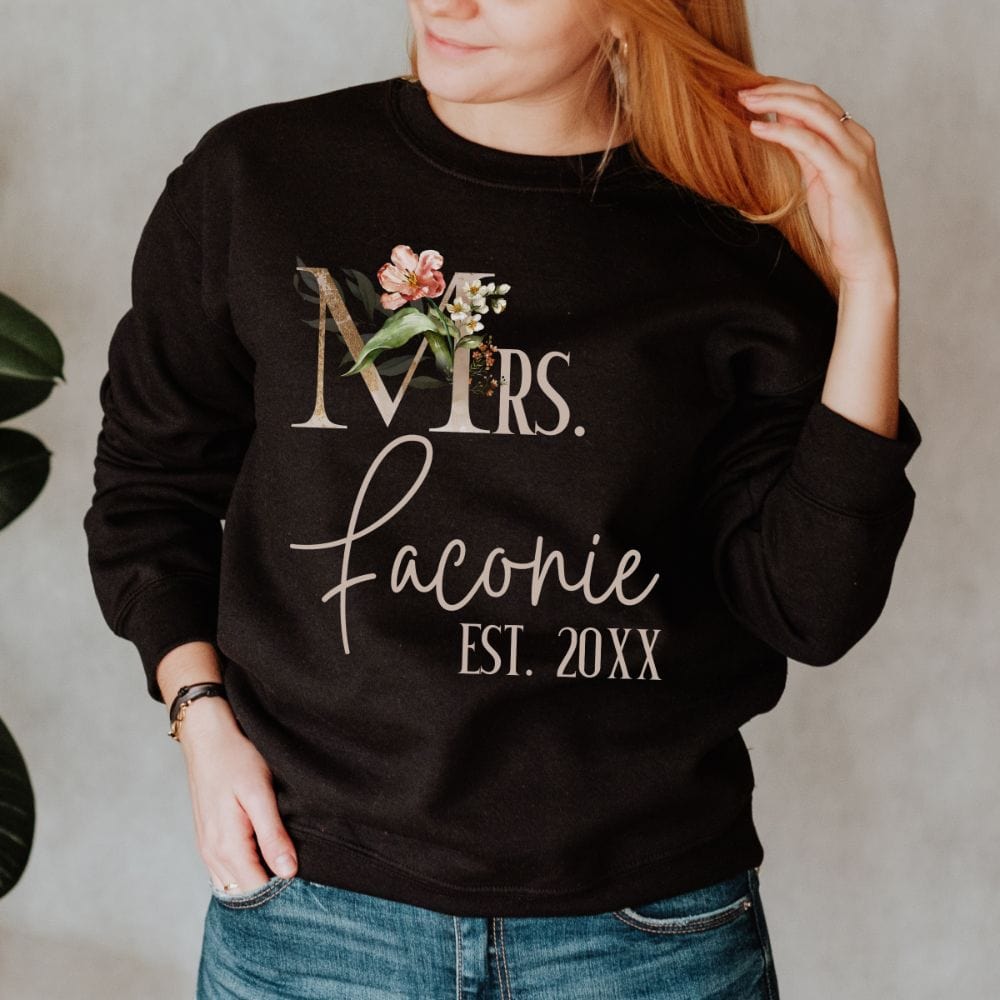 Customizable floral Mrs sweatshirt for fiancée, wife, spouse, BFF or bestie on your wedding or anniversary. Great idea for engagement announcement, bachelorette party, bridesmaid gift idea, rehearsal dinner outfit, and after wedding party gift. This cute getting ready outfit is a perfect idea for soon-to-be daughter-in-law, future Mrs. bride or as a honeymoon vacation souvenir. Personalize with name and date for a special touch.
