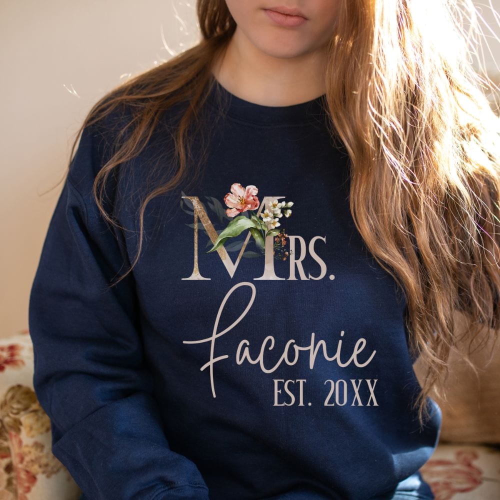 Customizable floral Mrs sweatshirt for fiancée, wife, spouse, BFF or bestie on your wedding or anniversary. Great idea for engagement announcement, bachelorette party, bridesmaid gift idea, rehearsal dinner outfit, and after wedding party gift. This cute getting ready outfit is a perfect idea for soon-to-be daughter-in-law, future Mrs. bride or as a honeymoon vacation souvenir. Personalize with name and date for a special touch.