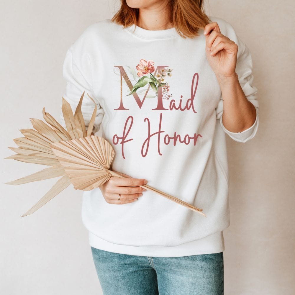 Floral maid of honor wedding party sweatshirt for matron of honor. Great idea for engagement announcement, bachelorette party, bridesmaid proposal box gift idea, rehearsal dinner, and after wedding parties. This cute getting ready outfit is a perfect addition for the bride's crew, team or squad.