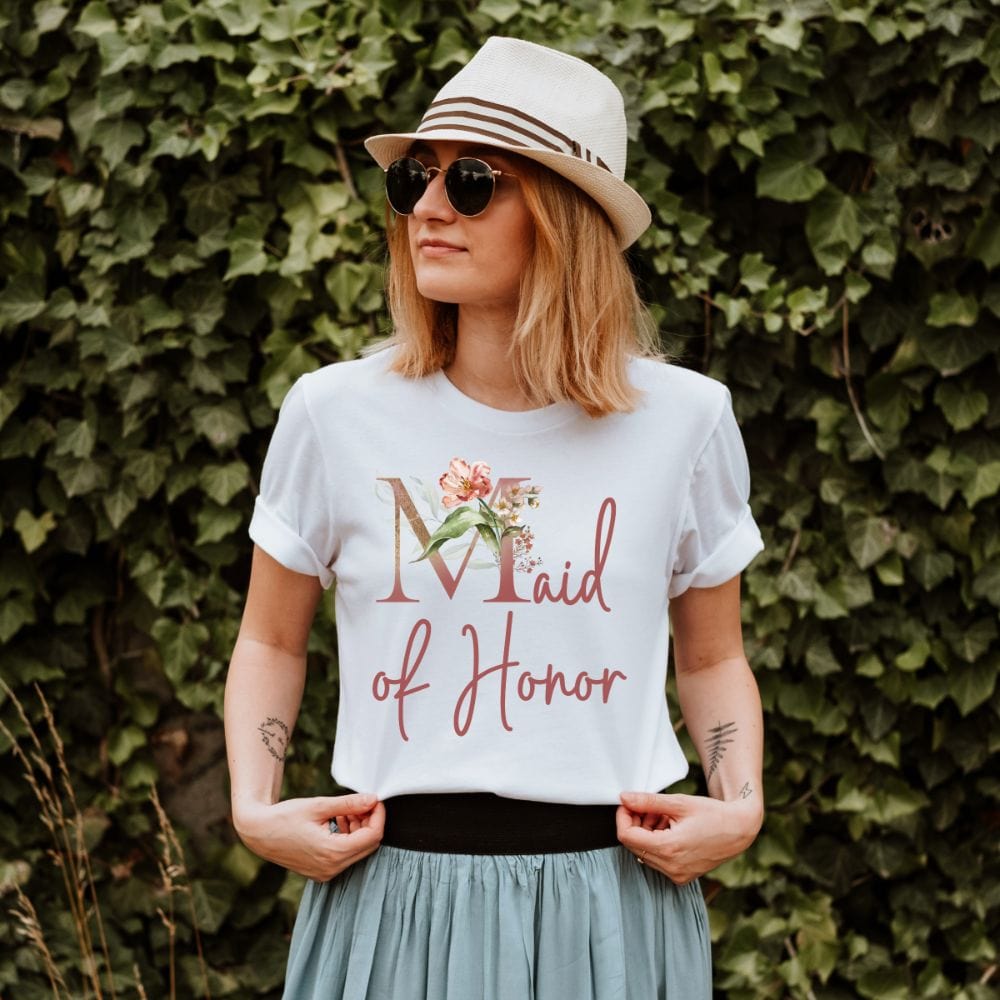 Floral maid of honor wedding party shirt for matron of honor. Great idea for engagement announcement, bachelorette party, bridesmaid proposal box gift idea, rehearsal dinner, and after wedding parties. This cute getting ready casual tee is a perfect addition for the bride's crew, team or squad.