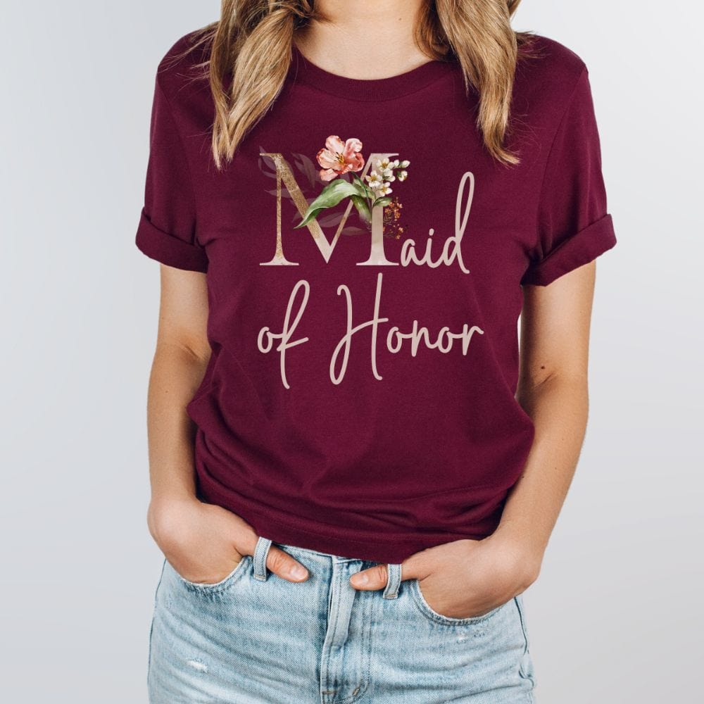 Floral maid of honor wedding party shirt for matron of honor. Great idea for engagement announcement, bachelorette party, bridesmaid proposal box gift idea, rehearsal dinner, and after wedding parties. This cute getting ready casual tee is a perfect addition for the bride's crew, team or squad.