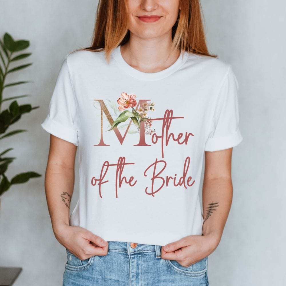 Floral mother of the bride wedding party shirt for mom. Great idea for engagement announcement, rehearsal dinner, and after wedding parties. This cute getting ready apparel is a perfect addition to the bride's crew, team or squad.