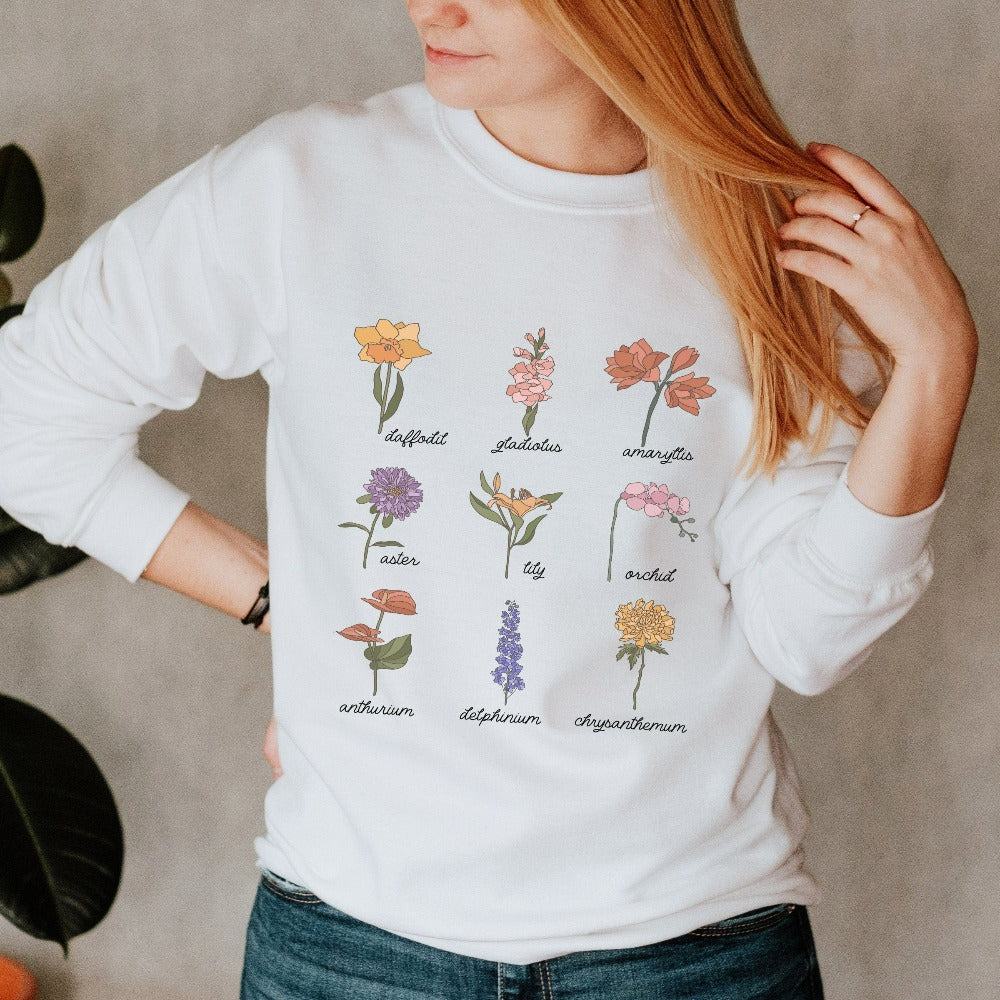 Wildflower graphic sweatshirt showing daffodil, gladiolus, amaryllis, aster, lily, orchid, anthurium, delphinium and chrysanthemum. This botanical wild flower pullover is great for Mother's Day, birthday, Christmas holidays, gift for best friend, daughter, mom or loved one especially anyone that loves nature, flowers and adorable watercolor outfits.