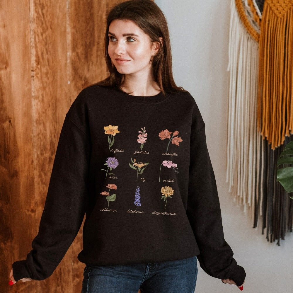 Wildflower graphic sweatshirt showing daffodil, gladiolus, amaryllis, aster, lily, orchid, anthurium, delphinium and chrysanthemum. This botanical wild flower pullover is great for Mother's Day, birthday, Christmas holidays, gift for best friend, daughter, mom or loved one especially anyone that loves nature, flowers and adorable watercolor outfits.
