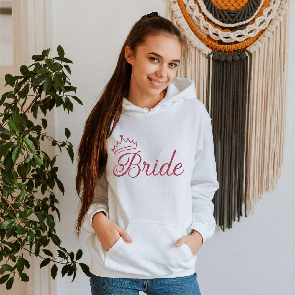 This cute bride sweatshirt is a great addition to getting ready for your wedding day. Serves as an engagement announcement surprise shirt; bachelorette party outfit; gift from bridesmaid or maid of honor; rehearsal night dinner outfit; and errand top for your wedding planning activities. So, if you have a soon to be bride, future Mrs. friend, or future daughter-in-law, this comfy hoodie is a great gift idea for her.