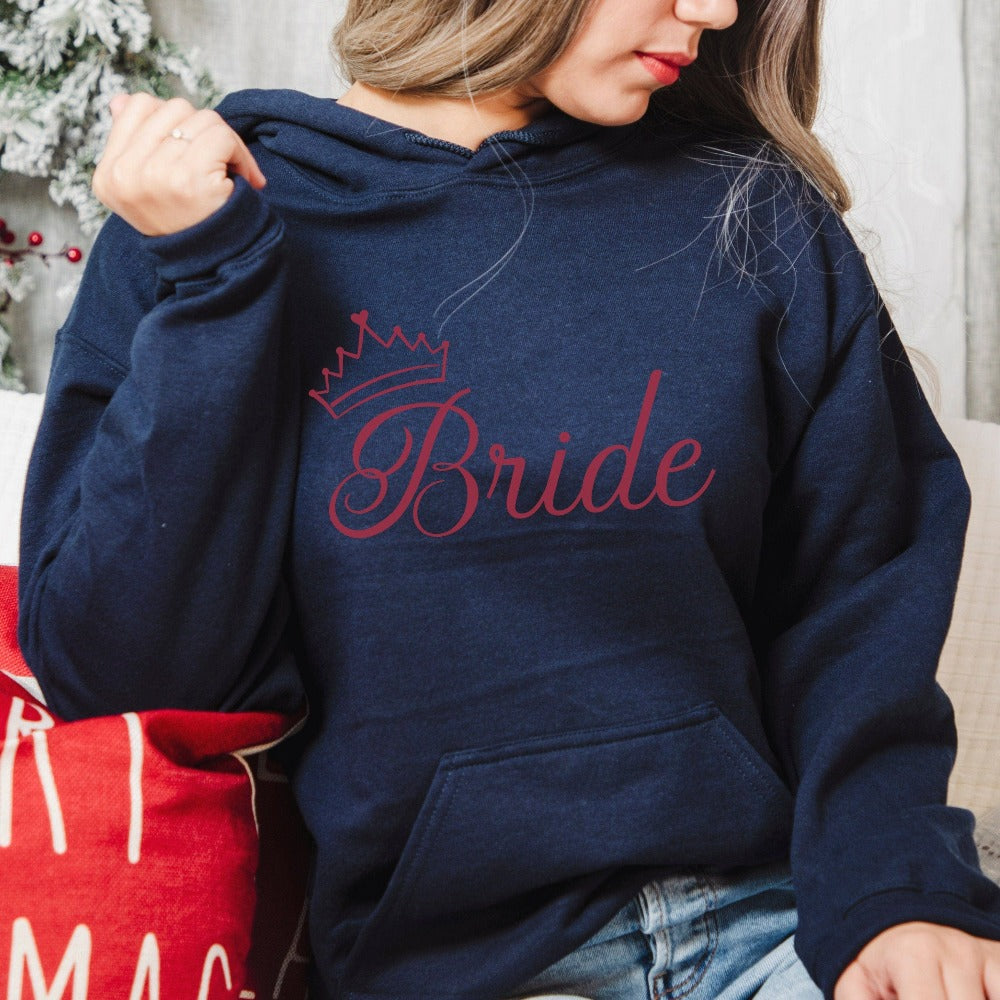 This cute bride sweatshirt is a great addition to getting ready for your wedding day. Serves as an engagement announcement surprise shirt; bachelorette party outfit; gift from bridesmaid or maid of honor; rehearsal night dinner outfit; and errand top for your wedding planning activities. So, if you have a soon to be bride, future Mrs. friend, or future daughter-in-law, this comfy hoodie is a great gift idea for her.
