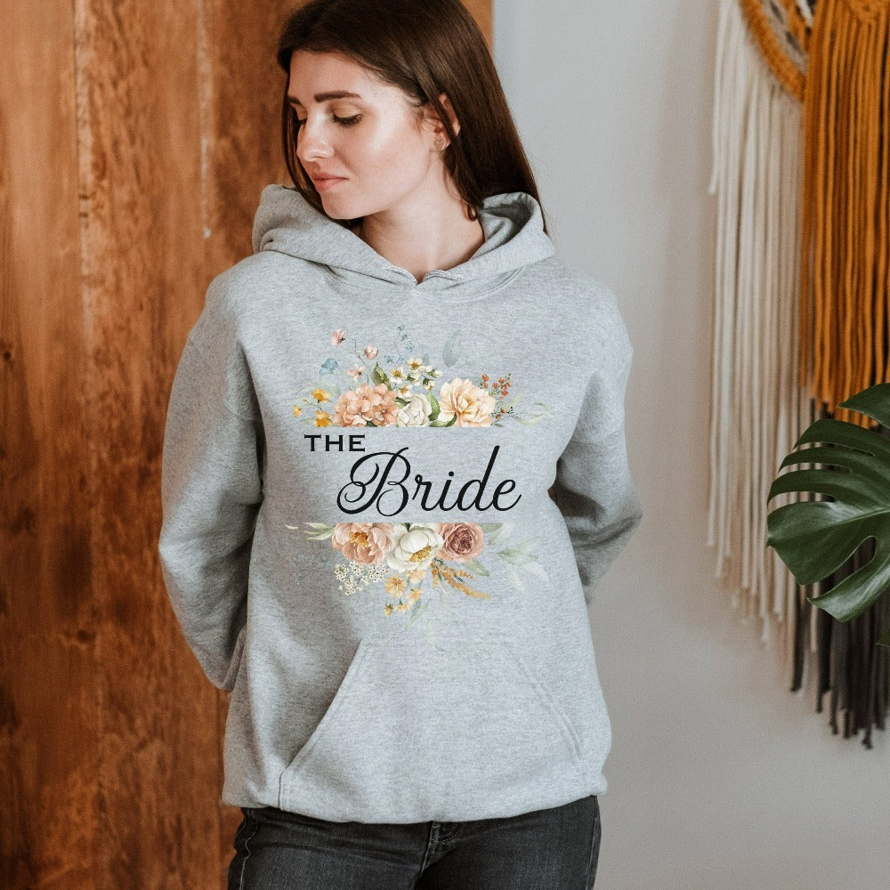 This floral bride sweatshirt is a dream and a great addition while getting ready for your wedding day. Works as an engagement announcement surprise shirt, bachelorette party outfit, gift from bridesmaid or maid of honor, rehearsal night dinner outfit and errand top for your wedding planning activities. So, if you have a soon to be bride, future Mrs. friend, or future daughter-in-law, this cozy hoodie is a great gift idea for her.
