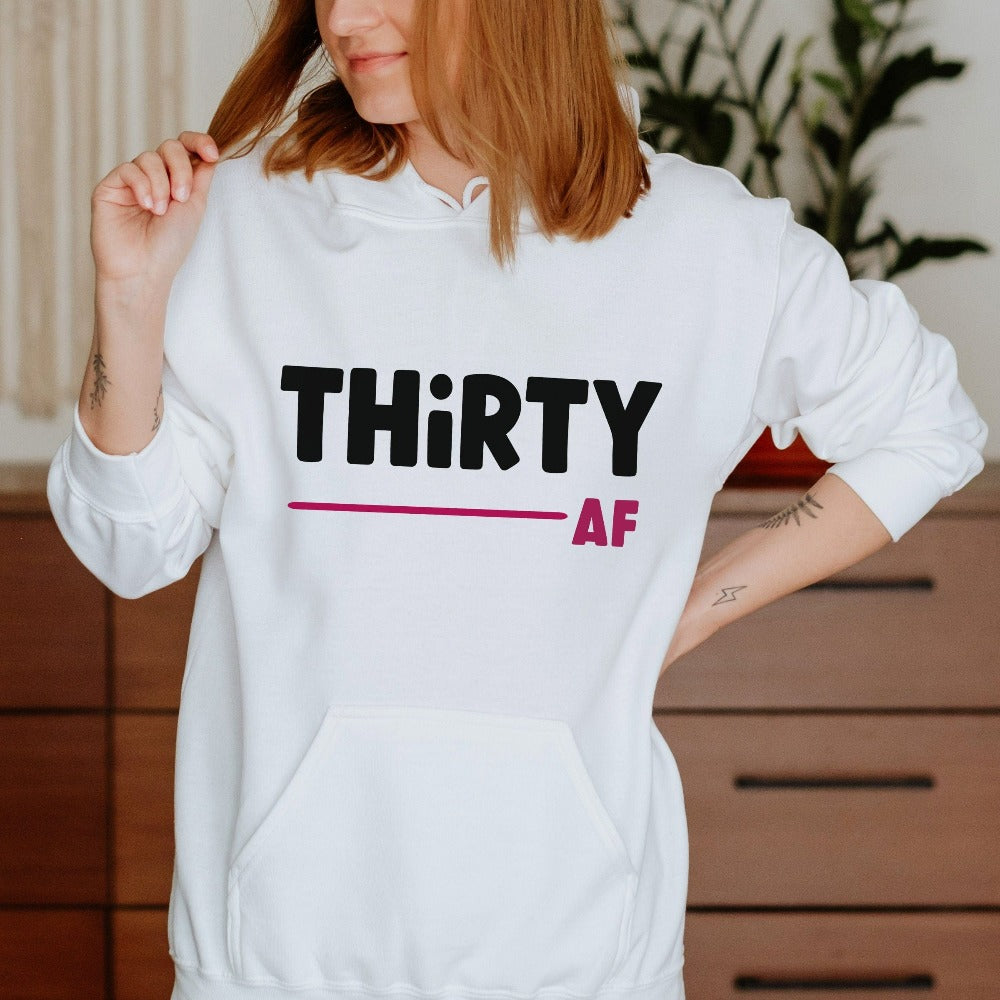 "Hello Thirty". Planning of a birthday celebration? Let's get this trendy thirty hoodie as a female matching outfit on 30th birthday for yourself, mom, sister, daughter and bestfriend on any birthday celebration ideas like a party or road trip.