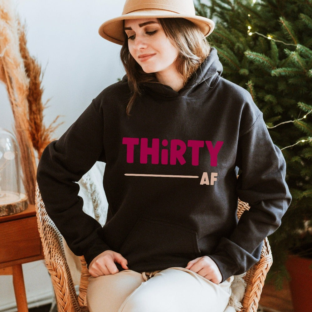 "Hello Thirty". Planning of a birthday celebration? Let's get this trendy thirty hoodie as a female matching outfit on 30th birthday for yourself, mom, sister, daughter and bestfriend on any birthday celebration ideas like a party or road trip.