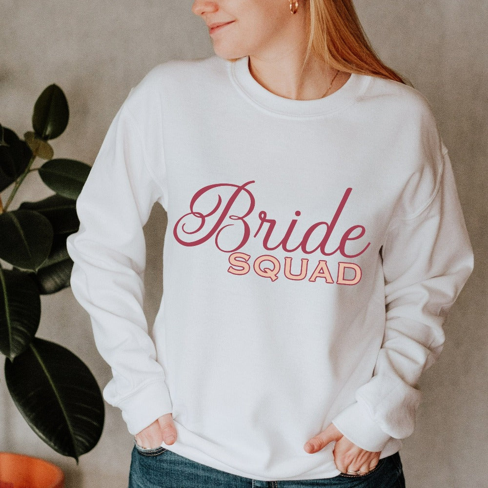 This matching bride squad sweatshirt is a perfect bridesmaid invitation or proposal box gift idea. Perfect as an engagement announcement surprise shirt, bachelorette party outfit, gift for bridesmaid or maid of honor, rehearsal night dinner outfit for mother of the bride, mother of the groom and any other crew member involved in your wedding planning activities.