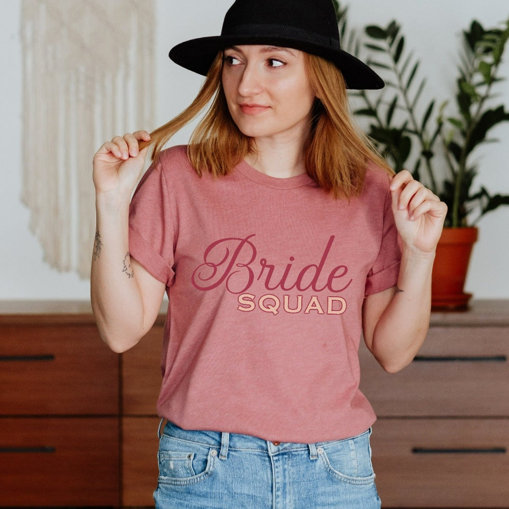 This matching bride squad shirt is a perfect bridesmaid invitation or proposal box gift idea. Perfect as an engagement announcement surprise shirt, bachelorette party casual tee, gift for bridesmaid or maid of honor, rehearsal night dinner outfit for mother of the bride, mother of the groom and any other crew member involved in your wedding planning activities.