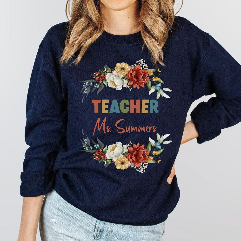 Customized floral botanical back to school teacher sweatshirt gift idea. This adorable shirt is for first day of school, last day, summer break or everyday appreciation present for your favorite kindergarten or grade teacher. Personalize with name with this positive outfit perfect for both classroom and field trip activities.