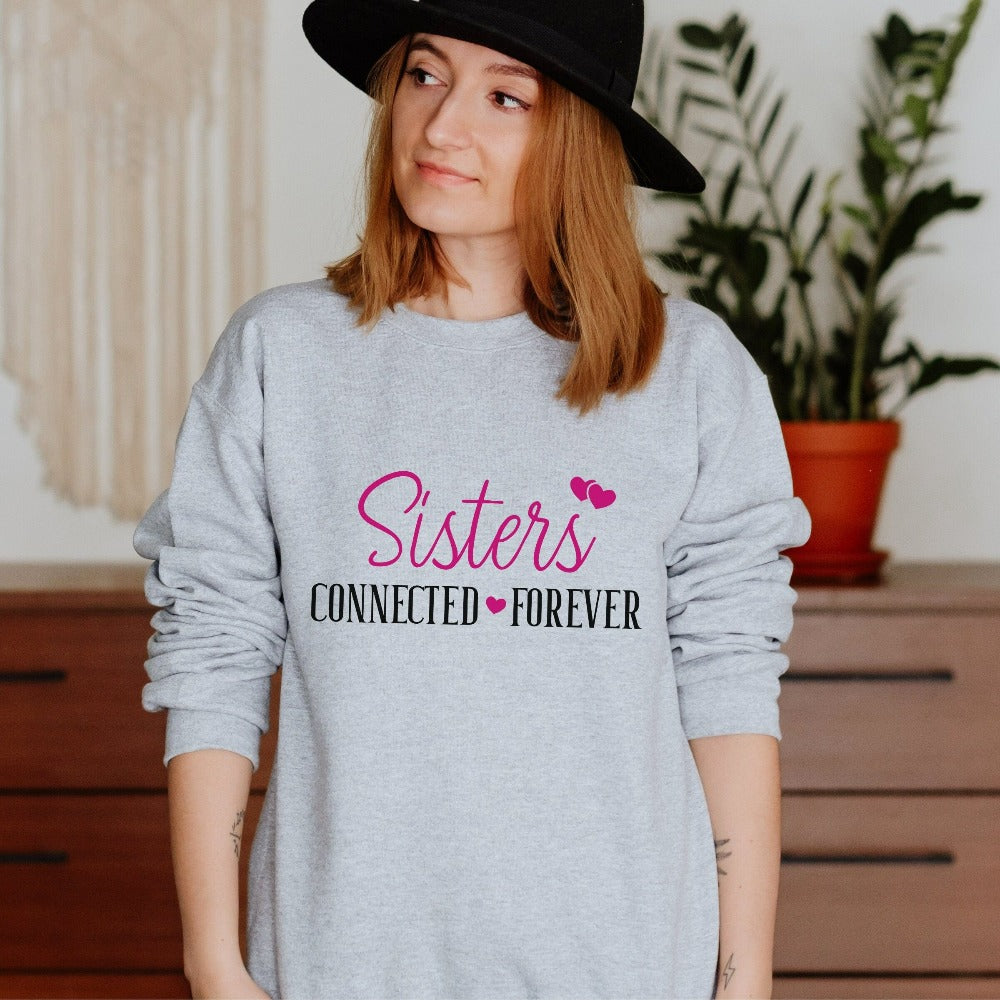 Adorable connected sisters' matching sweatshirt gift idea. Whether she is a long distance away or close by, celebrate your sister by birth, sorority, chance or circumstance with this lovely matching outfit for your loved one or twin. Cute shirt for cruise vacations, family camping reunion, birthdays, Christmas holiday, Thanksgiving visit, girls road trip or airport travel. 