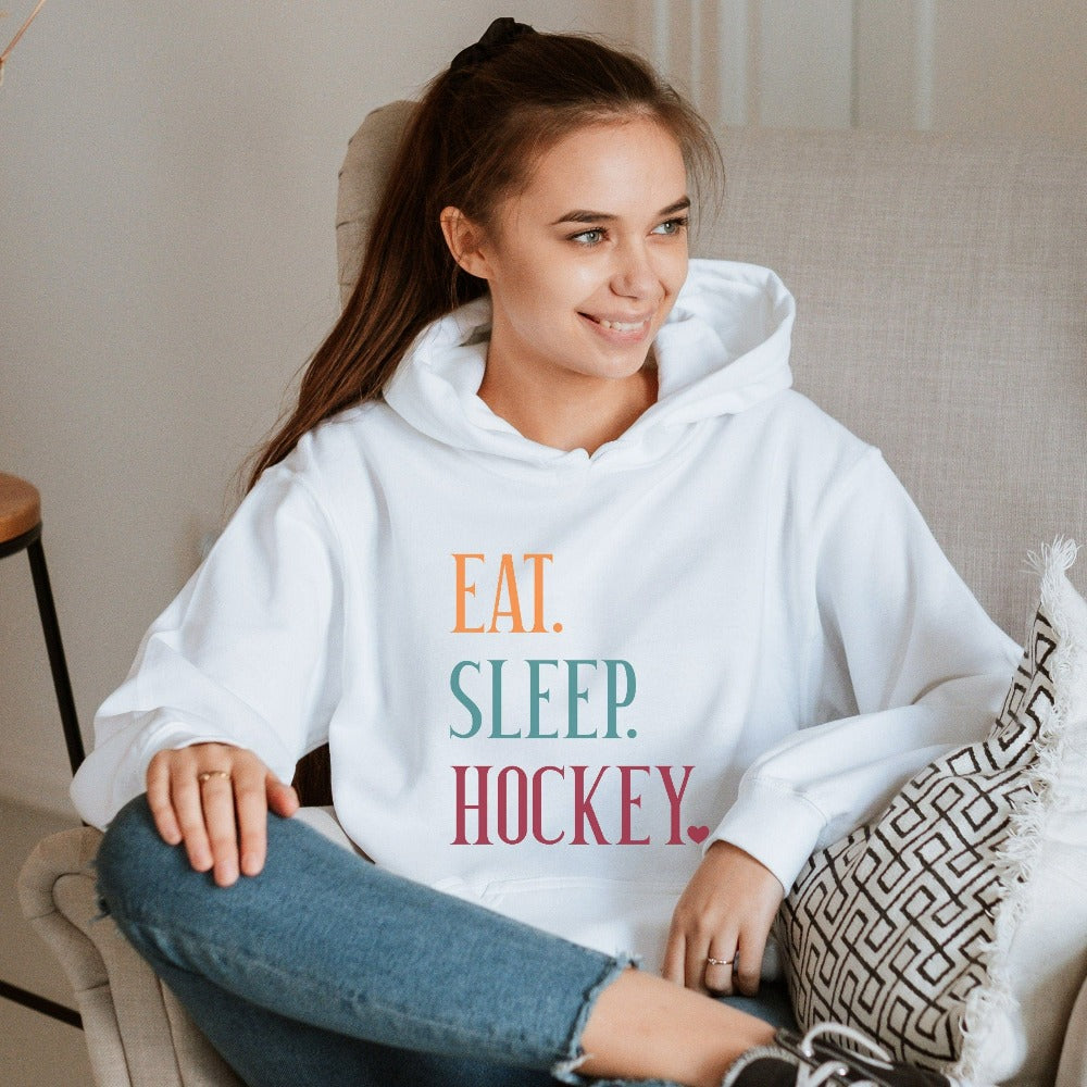 Eat, Sleep, Hockey sweatshirt. It's always sports season depending on how you play. This playful hoodie gift idea for your favorite athlete or soccer mom is bright and cheerful. Great for cheering on your team, getting ready for practice, heading out for a match and being the number one fan you have always been. Perfect hockey mom or dad outfit.