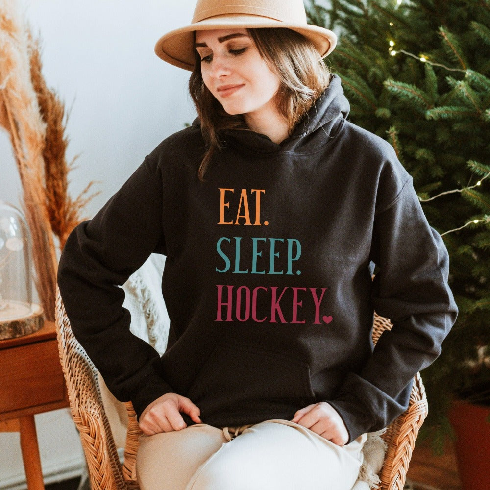 Eat, Sleep, Hockey sweatshirt. It's always sports season depending on how you play. This playful hoodie gift idea for your favorite athlete or soccer mom is bright and cheerful. Great for cheering on your team, getting ready for practice, heading out for a match and being the number one fan you have always been. Perfect hockey mom or dad outfit.